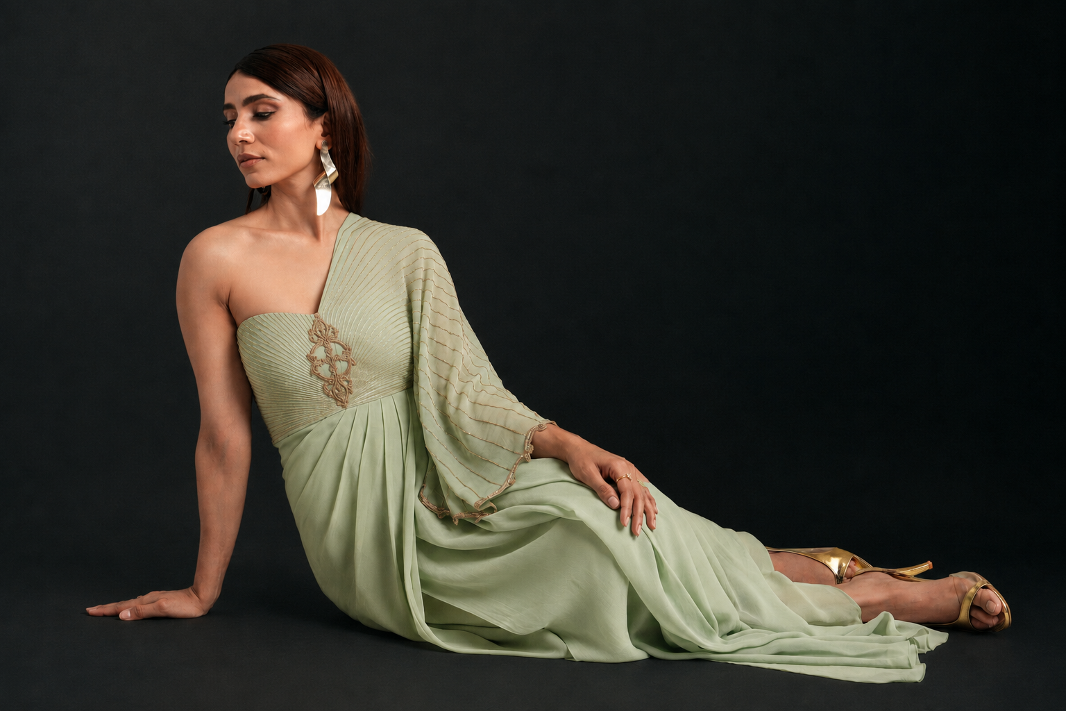 Model in a mint green pre-draped saree from the festive collection