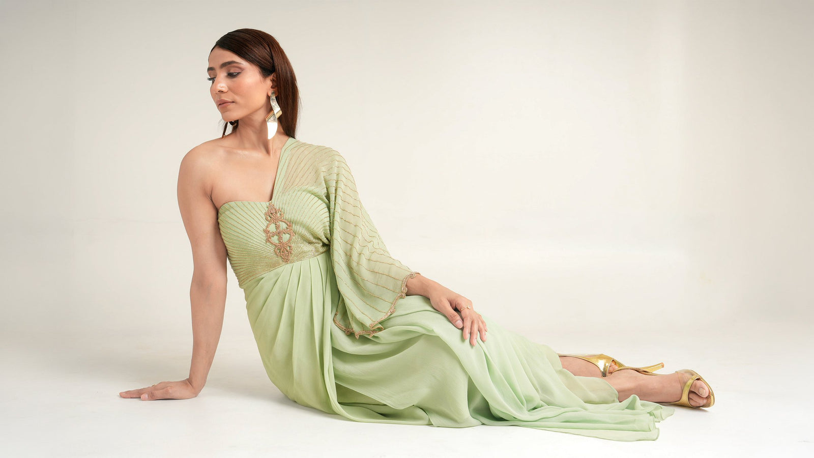 Model in a mint green pre-draped saree from the festive collection